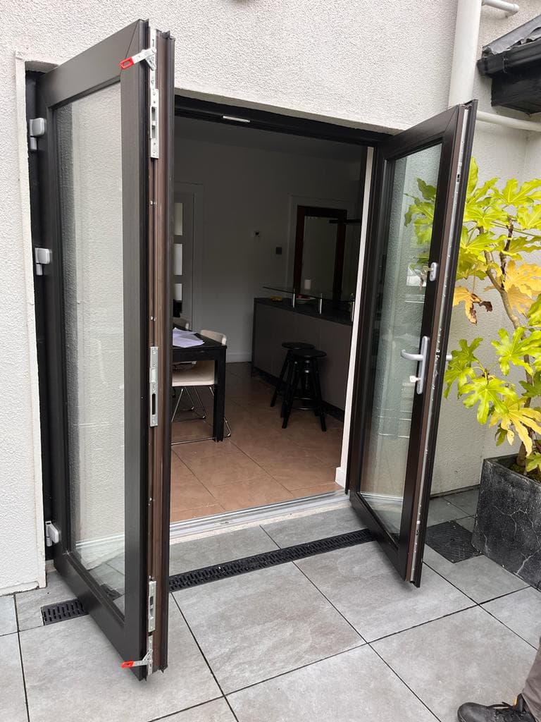 Open French doors showing the multi-point locking keeps on the frame, fitted by KRB Construction and Windows in Galway