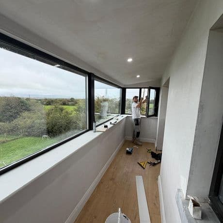 KRB fitter completing the corner opening window in a new extension with large picture windows